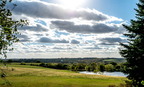 Clouds over pond near noon